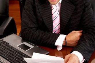 A businessman reviews documents, highlighting the importance of vet compliance.