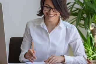 A businesswoman takes notes at her desk, reflecting the changing landscape of the vet sector.