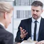 A professional interviews a candidate, illustrating assessment processes in the vet sector.
