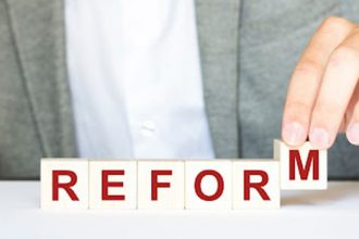 A hand builds the word 'reform' with letter blocks, representing VET qualifications reform.