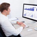 A business professional analyzes data on a computer, demonstrating the importance of contextualisation in vet training.