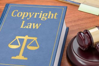 A law book and gavel illustrate copyright law and legal recourse for infringement.